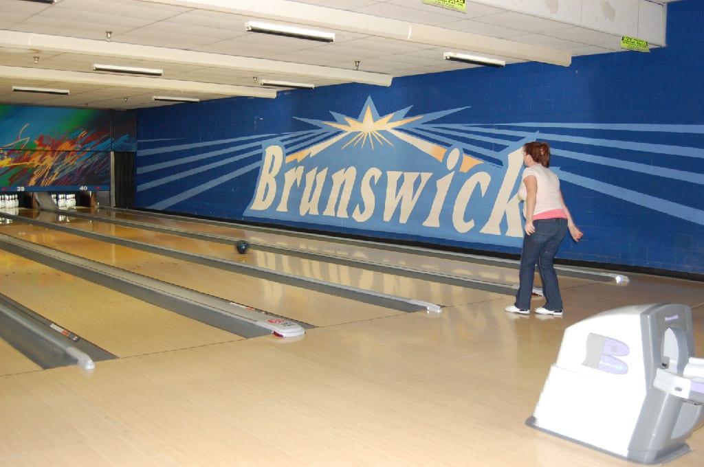A Sidewall with Brunswick Written and A Bowler in Action