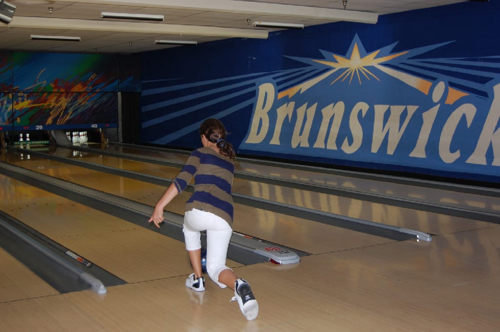 A Young Lady in Action at Brunswick Bowling Alley