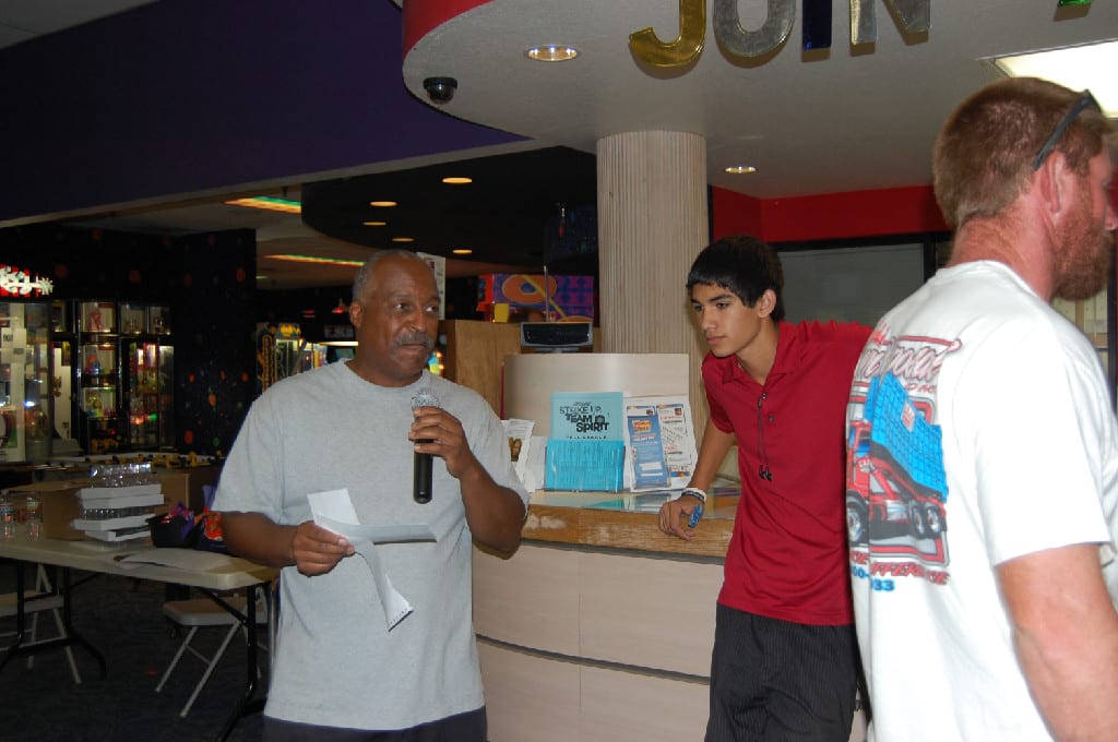 A Man with Mic Announcing at the Annual Bowling Tournament