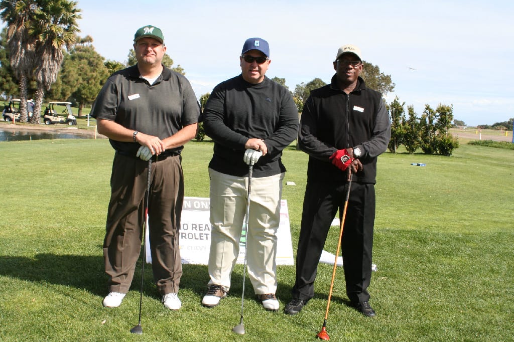 Three Men with Hats, Gloves, and Clubs Standing on the Ground