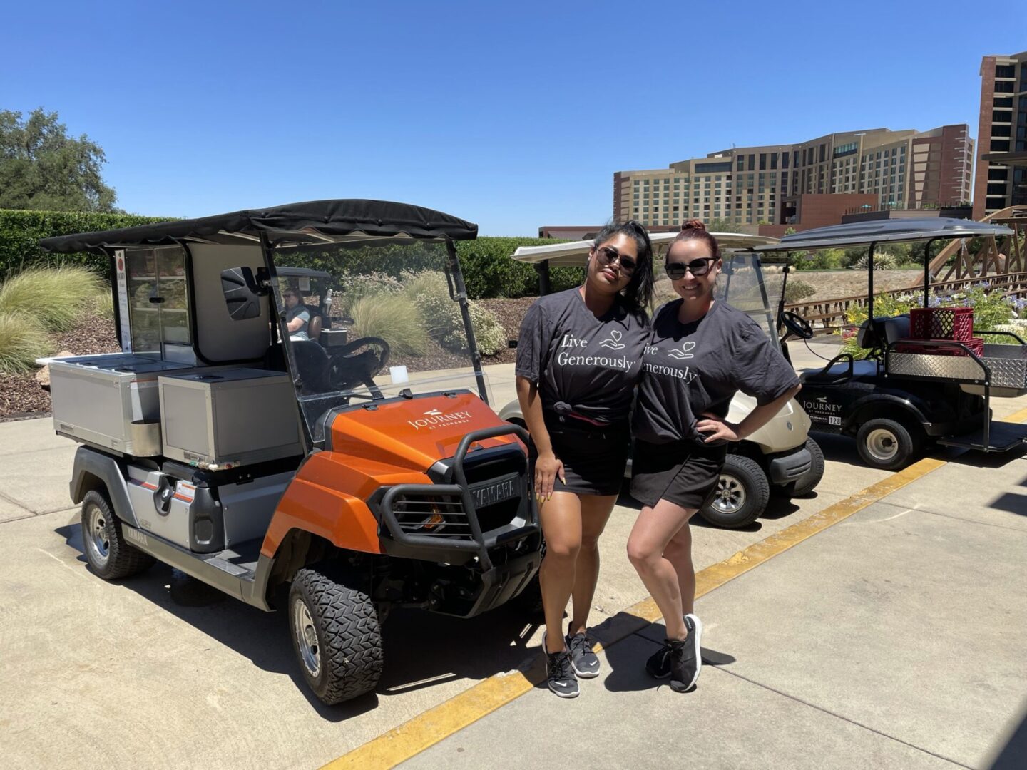 Beer Girls with Charity Shirts in Front of Golf Carts