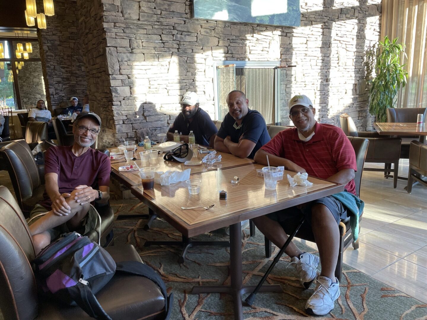 Team Jernigan Photographed Sitting with Stone Wall in the Back