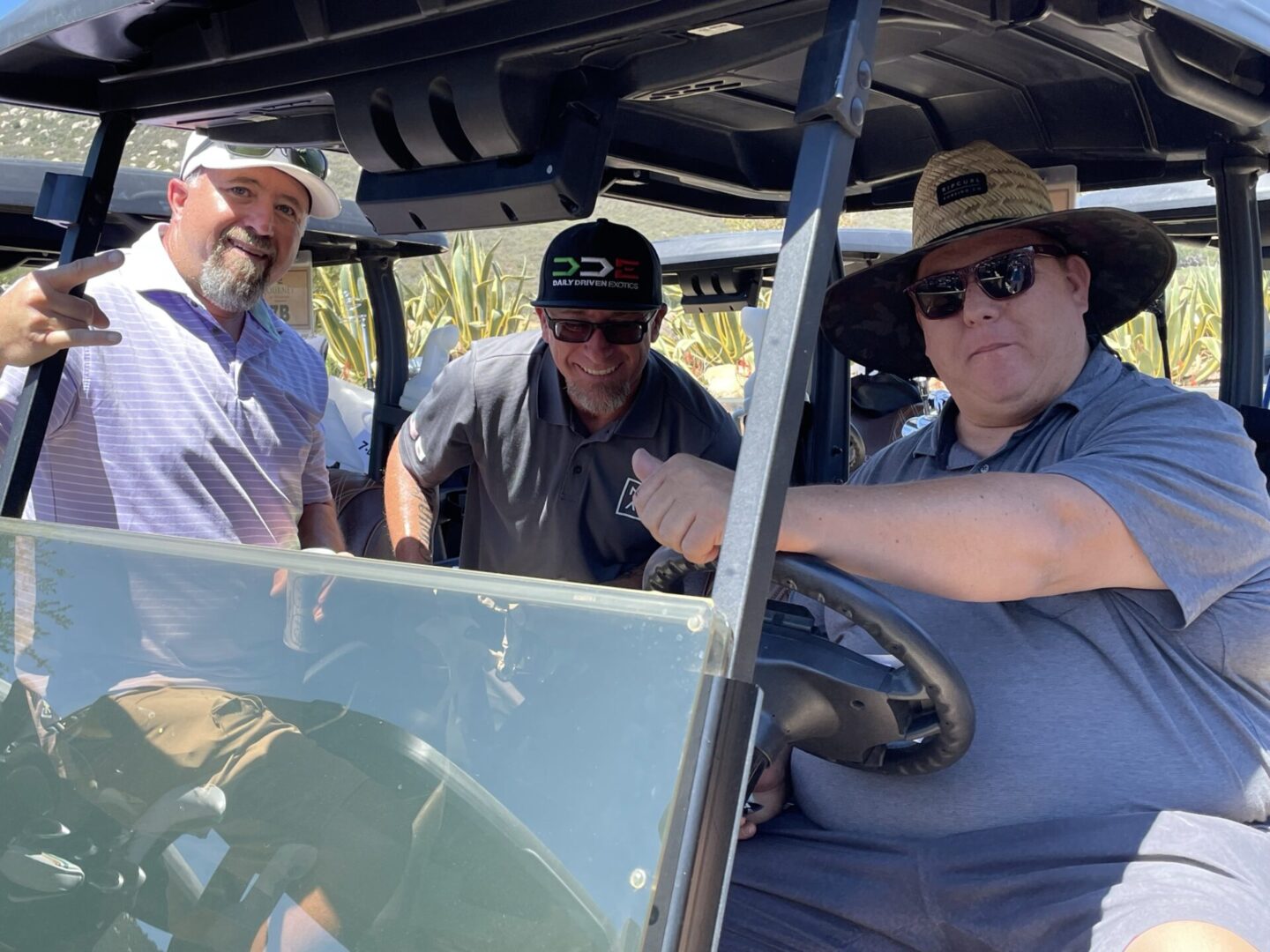 Team of Three Golfers Posing with Golf Cart for Photo